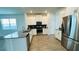 Modern kitchen boasts stainless appliances, a breakfast bar, and stylish tile flooring at 11296 Listening Dr, Orlando, FL 32832