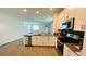 Open-concept kitchen with stainless steel appliances and a breakfast bar at 11296 Listening Dr, Orlando, FL 32832