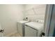 Convenient laundry room with washer, dryer, and storage shelving at 11296 Listening Dr, Orlando, FL 32832