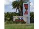 Entrance sign for Storey Park community surrounded by lush greenery and palm trees at 11296 Listening Dr, Orlando, FL 32832