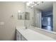 Bright bathroom features a quartz countertop, modern fixtures, and a large mirror at 121 Primrose Dr, Longwood, FL 32779