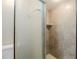 Ensuite bathroom with glass-enclosed shower and neutral tile at 121 Primrose Dr, Longwood, FL 32779