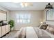 This virtually staged bedroom is bright and airy, with a large window and calming decor at 121 Primrose Dr, Longwood, FL 32779