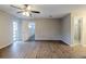 Open bedroom with updated flooring, two large windows, and ensuite bathroom at 121 Primrose Dr, Longwood, FL 32779