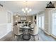 Elegant dining room with chandelier, neutral tones, and hardwood floors adjacent to living room at 121 Primrose Dr, Longwood, FL 32779