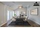 Virtually staged dining room with vaulted ceilings, neutral decor, and French door access to patio at 121 Primrose Dr, Longwood, FL 32779