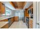 Cozy kitchen with stainless steel appliances, granite countertops, and light wood cabinets at 121 Primrose Dr, Longwood, FL 32779