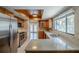 Well-lit kitchen with stainless steel appliances, wood cabinets, and large window over the sink at 121 Primrose Dr, Longwood, FL 32779