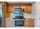 Updated kitchen features stainless steel appliances, light countertops, and wooden cabinets at 121 Primrose Dr, Longwood, FL 32779