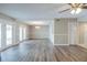 Light-filled living room with hardwood floors, neutral tones, and exterior access at 121 Primrose Dr, Longwood, FL 32779