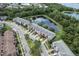 Overhead view of lovely townhomes alongside a pond, enhanced by mature landscaping and picturesque surroundings at 16064 Old Ash Loop, Orlando, FL 32828