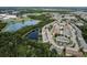 Aerial view showcasing the neighborhood, lakes, and surrounding landscape at 16064 Old Ash Loop, Orlando, FL 32828