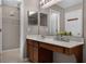 Bathroom vanity with white countertop and framed mirror at 16064 Old Ash Loop, Orlando, FL 32828