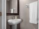 Half bathroom featuring a pedestal sink and towel rack at 16064 Old Ash Loop, Orlando, FL 32828