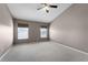 Bedroom with carpet flooring, neutral paint, and two windows at 16064 Old Ash Loop, Orlando, FL 32828