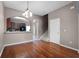 Open dining room with hardwood floors leading to the kitchen at 16064 Old Ash Loop, Orlando, FL 32828