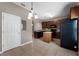 Open kitchen with tile flooring, island, wood cabinets, and black appliances at 16064 Old Ash Loop, Orlando, FL 32828