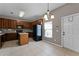 Kitchen with black appliances, window, and tile flooring open to an eating area at 16064 Old Ash Loop, Orlando, FL 32828