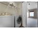 Functional laundry room featuring a washer, dryer, and overhead storage shelves at 16064 Old Ash Loop, Orlando, FL 32828