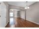 Living room with hardwood floors featuring an arched entryway at 16064 Old Ash Loop, Orlando, FL 32828