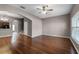 Spacious living room with hardwood floors and a ceiling fan at 16064 Old Ash Loop, Orlando, FL 32828