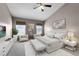 The main bedroom has neutral walls, two windows, a ceiling fan, and coordinated décor at 16064 Old Ash Loop, Orlando, FL 32828