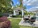 Beautiful backyard with pool, cabana, and outdoor dining area, perfect for entertaining at 1690 Palm Ave, Winter Park, FL 32789