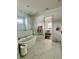 Bright bathroom featuring a soaking tub with marble tile surround and access to the main bedroom at 1690 Palm Ave, Winter Park, FL 32789