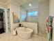 Bright bathroom featuring a standalone tub, glass shower, and stylish marble countertops at 1690 Palm Ave, Winter Park, FL 32789