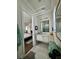 Bathroom with single vanity, toilet and combination shower/tub. Bedroom visible through doorway at 1690 Palm Ave, Winter Park, FL 32789