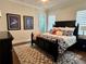 Cozy bedroom with a dark wood bed frame and patterned area rug at 1690 Palm Ave, Winter Park, FL 32789