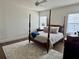 Calm bedroom with a four-poster bed and neutral decor at 1690 Palm Ave, Winter Park, FL 32789