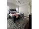This cozy bedroom features a ceiling fan, hardwood floors, and ensuite bathroom at 1690 Palm Ave, Winter Park, FL 32789