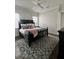 Bedroom features a patterned rug, ceiling fan and a large bed with decorative pillows at 1690 Palm Ave, Winter Park, FL 32789
