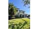 Charming two-story home with a well-manicured lawn and palm trees at 1690 Palm Ave, Winter Park, FL 32789