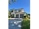 Charming two-story home with a brick driveway and mature landscaping at 1690 Palm Ave, Winter Park, FL 32789