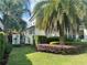 A serene side view of the home with a well-maintained lawn and verdant garden at 1690 Palm Ave, Winter Park, FL 32789