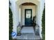 Front entryway featuring a large blue door, lanterns, and lush landscaping at 1690 Palm Ave, Winter Park, FL 32789