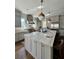 Bright kitchen features an island with seating, stainless steel appliances, and hanging pendant lights at 1690 Palm Ave, Winter Park, FL 32789