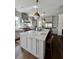 Bright kitchen features an island with seating, stainless steel appliances, and hanging pendant lights at 1690 Palm Ave, Winter Park, FL 32789