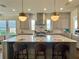 Spacious kitchen with marble-topped island, pendant lighting, and stainless steel appliances at 1690 Palm Ave, Winter Park, FL 32789