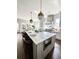 Bright kitchen features an island with seating, stainless steel appliances, and hanging pendant lights at 1690 Palm Ave, Winter Park, FL 32789
