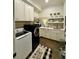 Well-organized laundry room with white cabinets, modern appliances, and stylish decor at 1690 Palm Ave, Winter Park, FL 32789