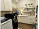 A well-organized laundry room featuring modern appliances and ample counter space at 1690 Palm Ave, Winter Park, FL 32789