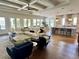Open-concept living room with hardwood floors, a coffered ceiling, and a modern kitchen at 1690 Palm Ave, Winter Park, FL 32789