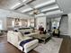 Open-concept living room with hardwood floors and coffered ceilings leads into the kitchen and stairway at 1690 Palm Ave, Winter Park, FL 32789