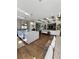 Open-concept design featuring a kitchen, dining, and living area with hardwood floors and coffered ceilings at 1690 Palm Ave, Winter Park, FL 32789
