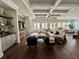 Bright living room features coffered ceilings, hardwood floors, and neutral decor for a relaxing atmosphere at 1690 Palm Ave, Winter Park, FL 32789