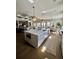 Open-concept design featuring a kitchen, dining, and living area with hardwood floors and coffered ceilings at 1690 Palm Ave, Winter Park, FL 32789