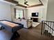 Living room featuring wooden beam ceilings, a shuffle board, and a plush sofa at 1690 Palm Ave, Winter Park, FL 32789